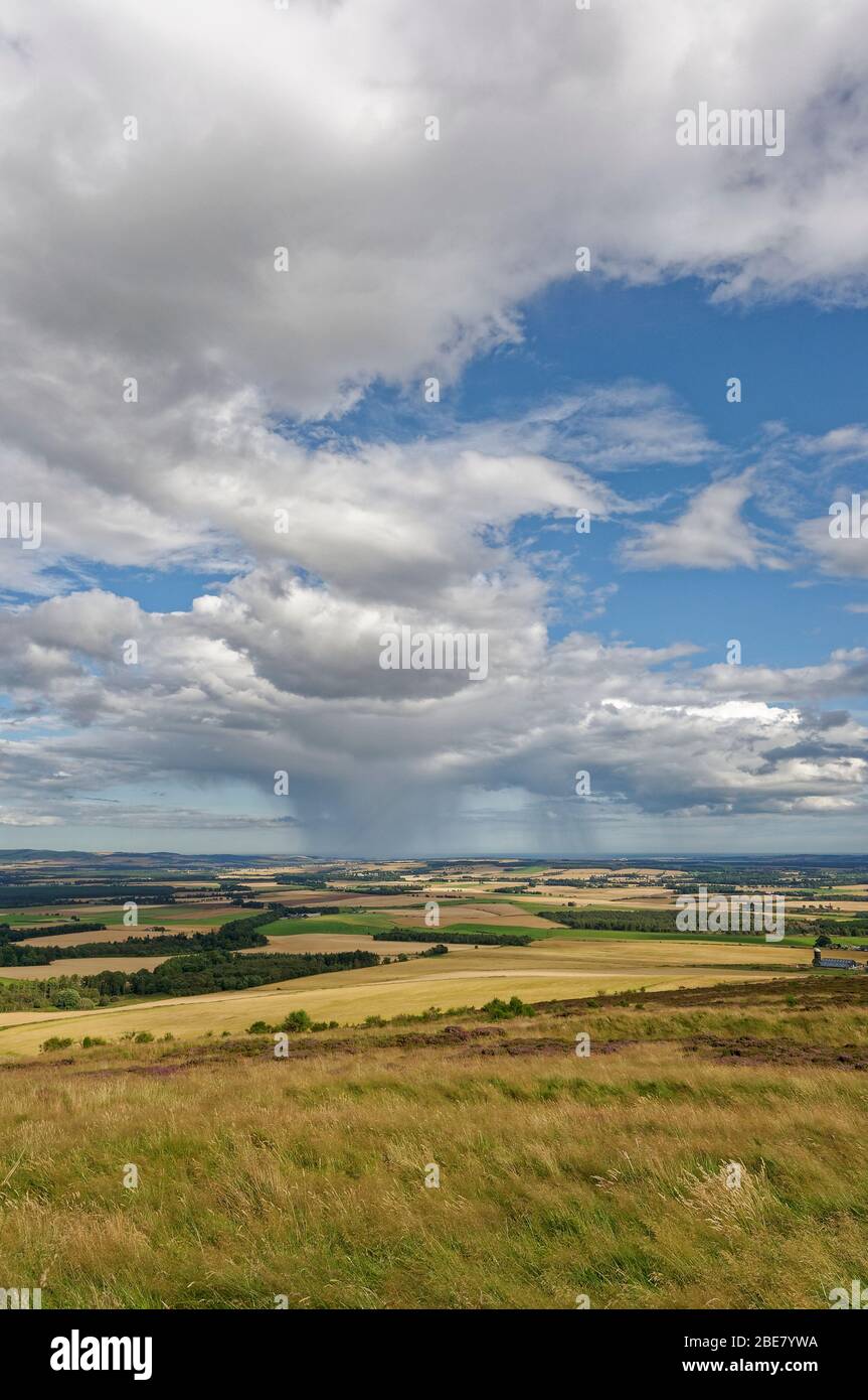 The view towards the East Coast of Scotland from the Summit of the White Caterthun Iron Age Fort, with Rain Clouds in the Distance. Stock Photo