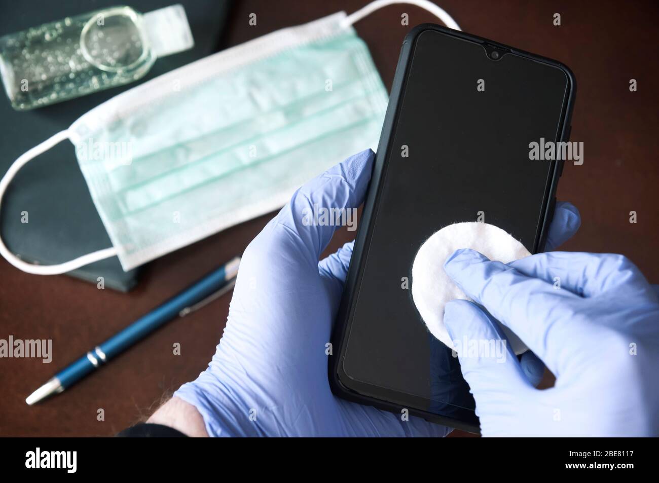 Pandemics precaution concept  - desinfection of a mobile phone Stock Photo