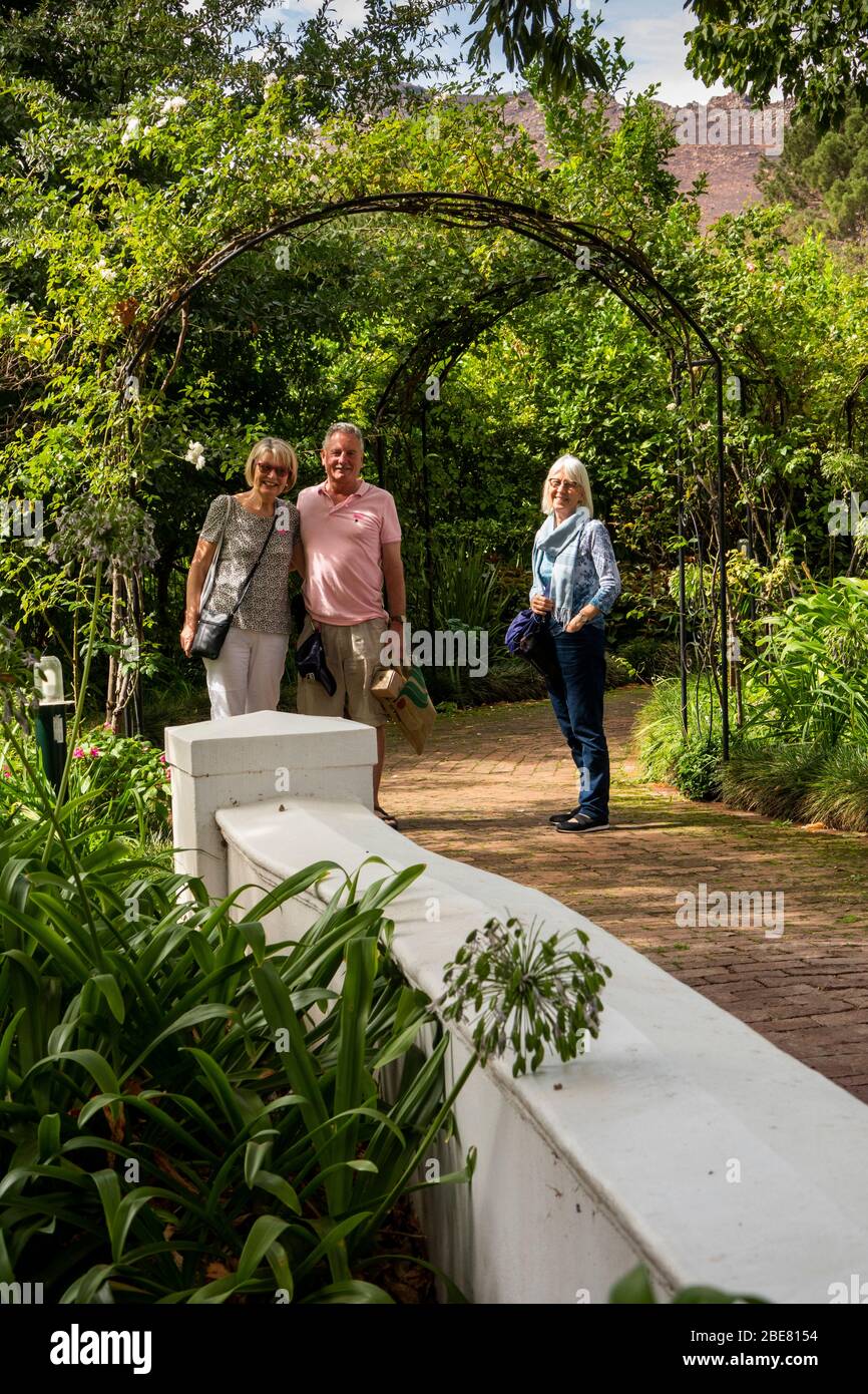 South Africa; Franschhoek; Moreson Winery, western tourists under arch in garden Stock Photo