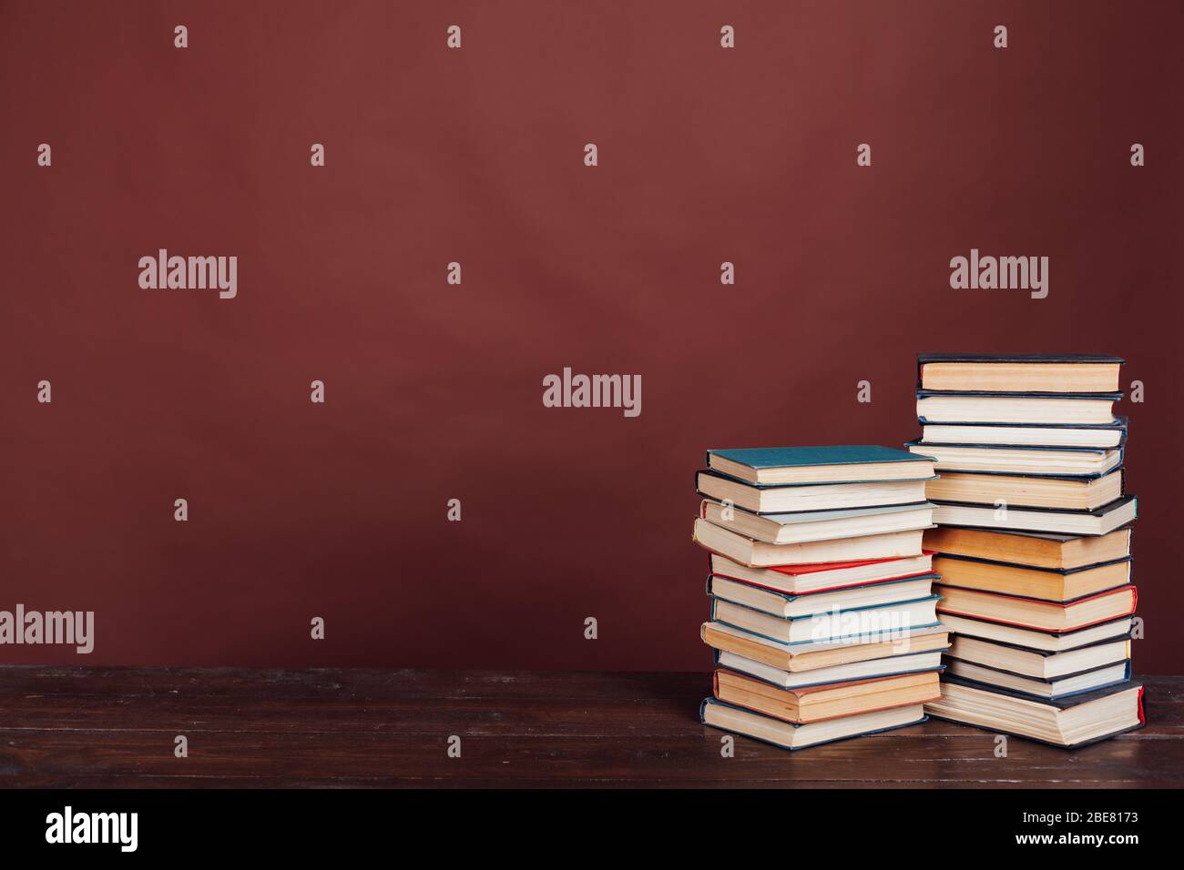 many stacks of educational books to study in the university library on ...