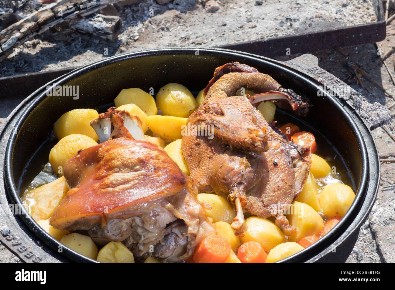 Cooking of traditional Croatian meal Peka in metal pots called sac
