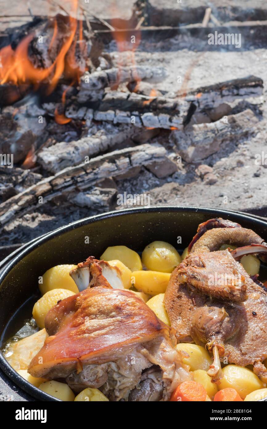 Cooking of traditional Croatian meal Peka in metal pots called sac