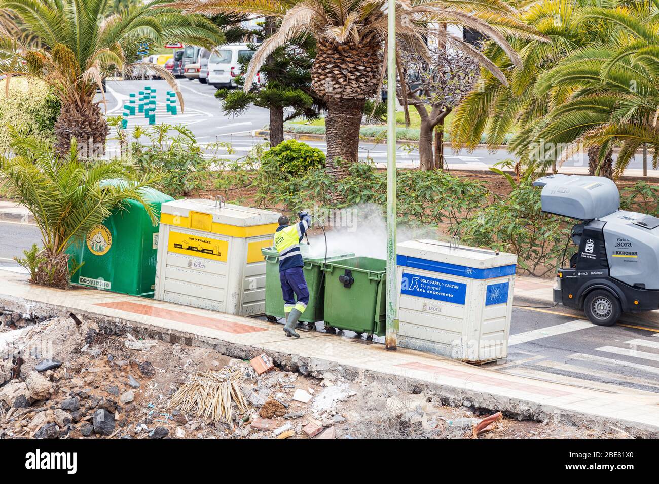 Jetwashing the bins with a disinfectant spray during the coronavirus pandemic in Playa San Juan, Tenerife, Canary Islands, Spain Stock Photo