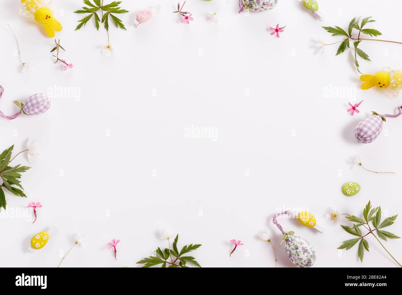 Easter background with Easter eggs and spring flowers. Top view with ...
