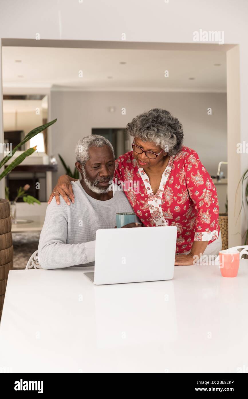 Mixed race woman using a laptop. Social distancing and self isolation in quarantine Stock Photo