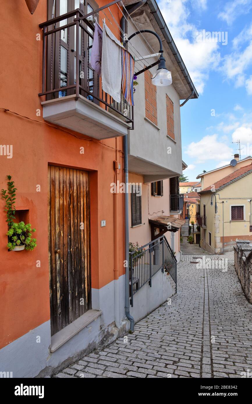 A narrow street between the old houses of Sant'Angelo dei Lombardi, a town in the province of Avellino, Italy Stock Photo