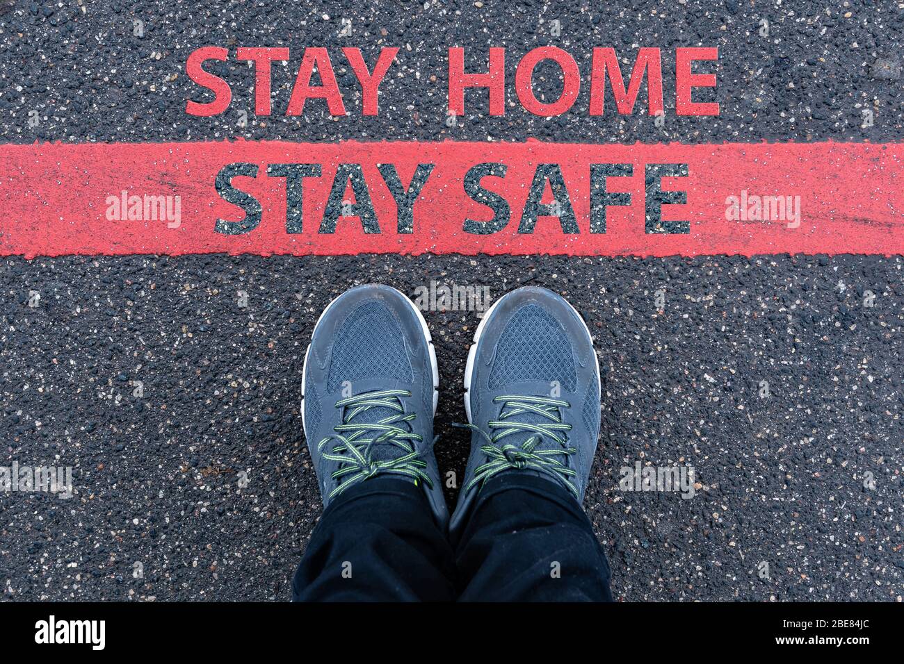 Restriction Stay man in sneakers standing next to a red line with text STAY HOME, STAY ...