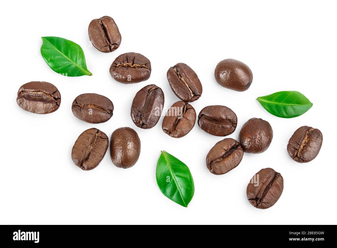 Heap of roasted coffee beans with leaves isolated on white background ...