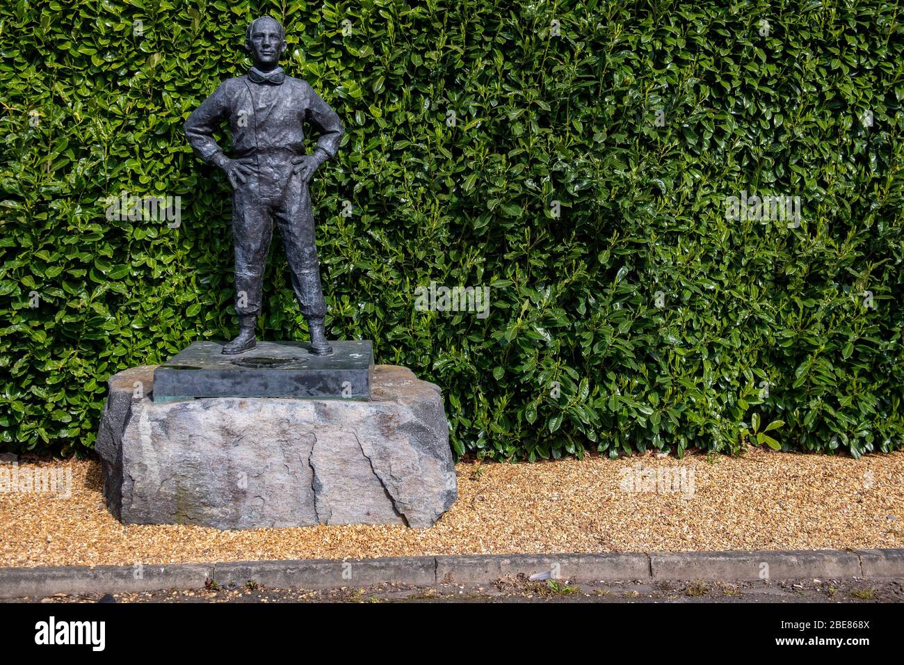 A statue of Sir Stirling Moss stands without any floral tributes at Mallory Park circuit, Leicestershire, following his death aged 90, with fans unable to visit due to the Coronavirus lockdown. Stock Photo