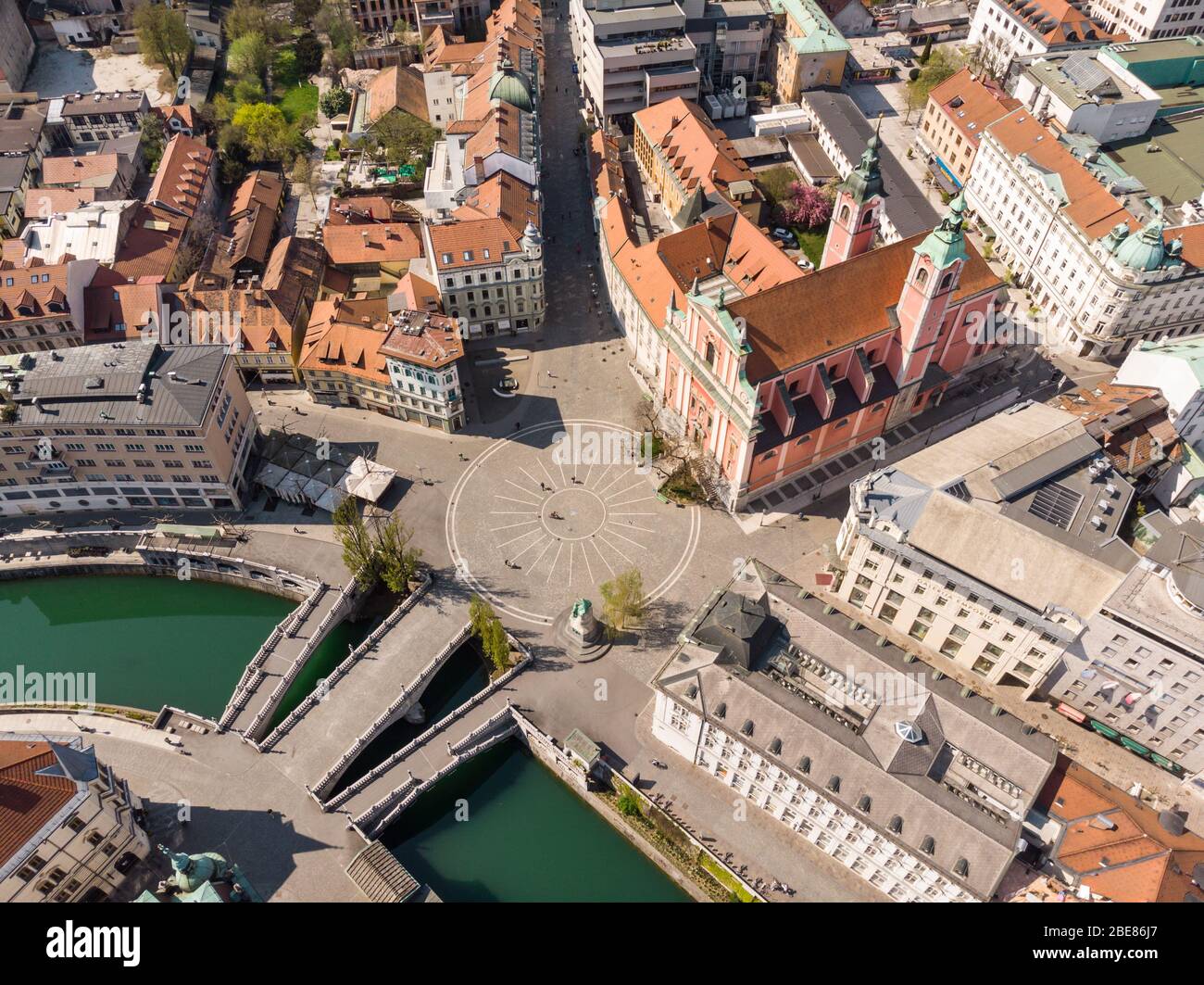 Aerial drone view of Preseren Squere and Triple Bridge over Ljubljanica river,Tromostovje, Ljubljana, Slovenia. Empty streets during corona virus Stock Photo