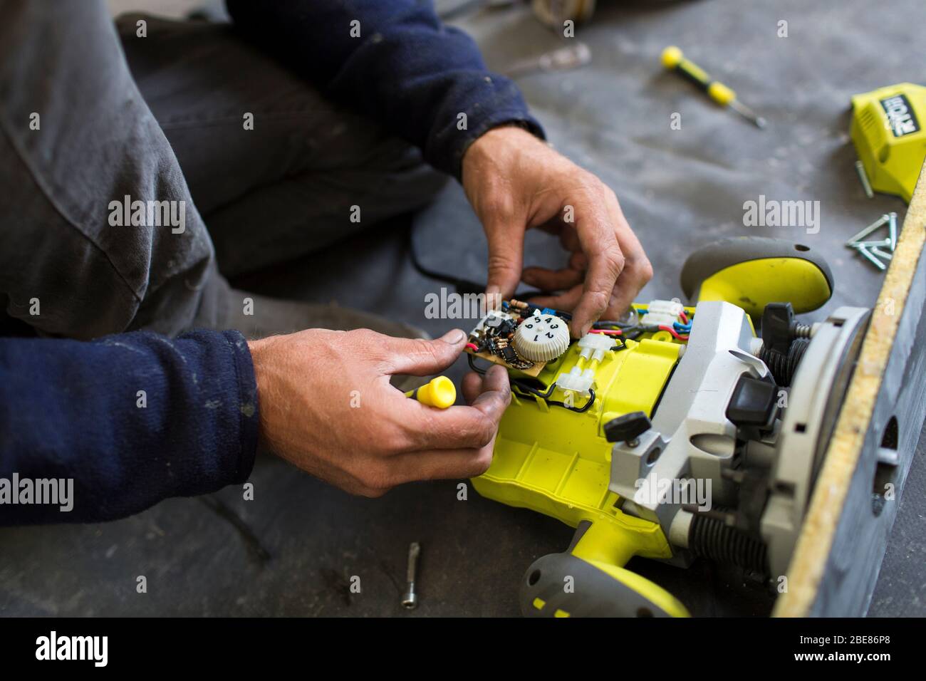 boatbuilder dismantles Ryobi to fix a broken connection. Laws regarding the right to repair are changing people's Etel France Stock Photo - Alamy