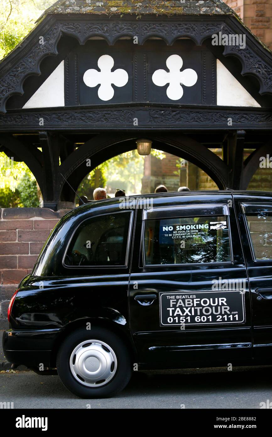 Black Taxi Tour parked in front of St Peters Church in Woolton Village Liverpool, where John Lennon and Paul McCartney first played together Stock Photo