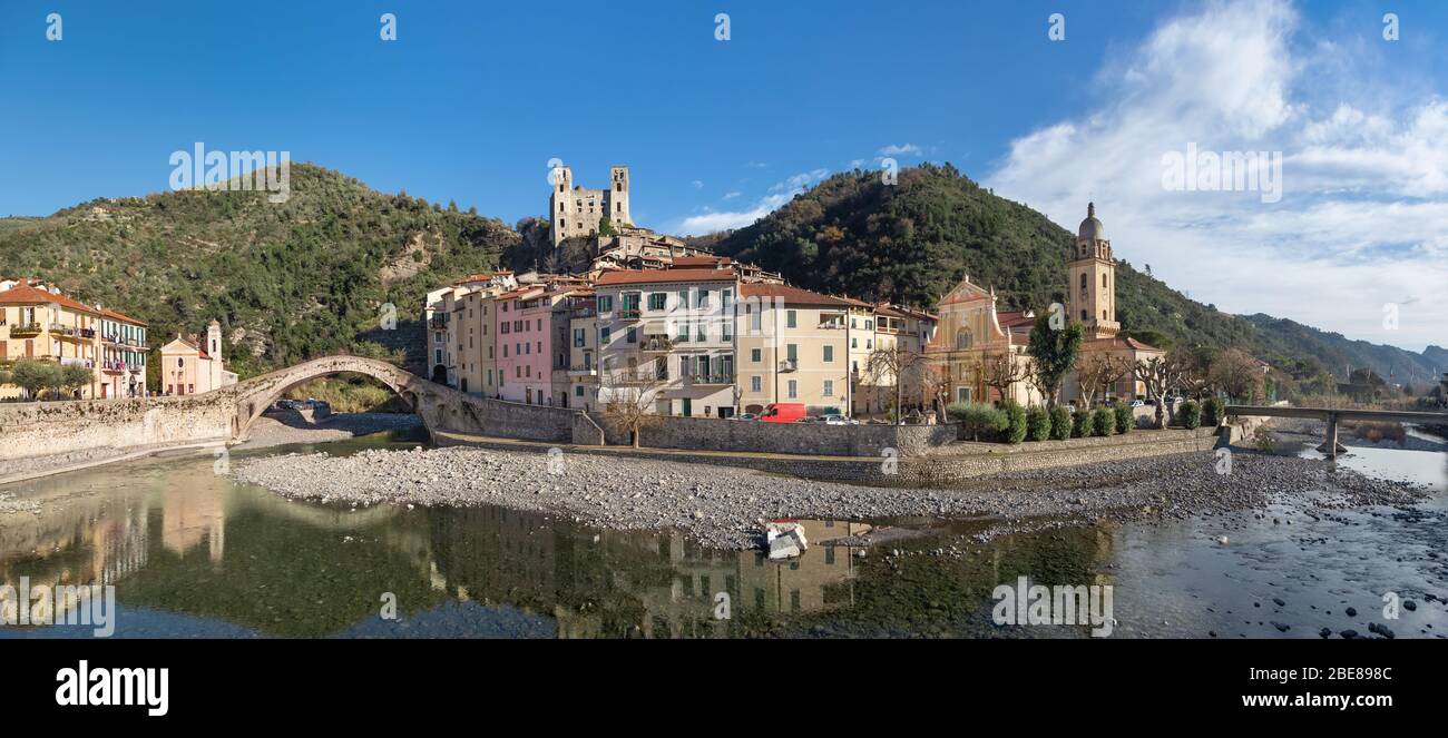 Dolceacqua, Italy. Panorama of the town with romanesque bridge (Ponte Vecchio), over the Nervia river and ruins of medieval castle Stock Photo