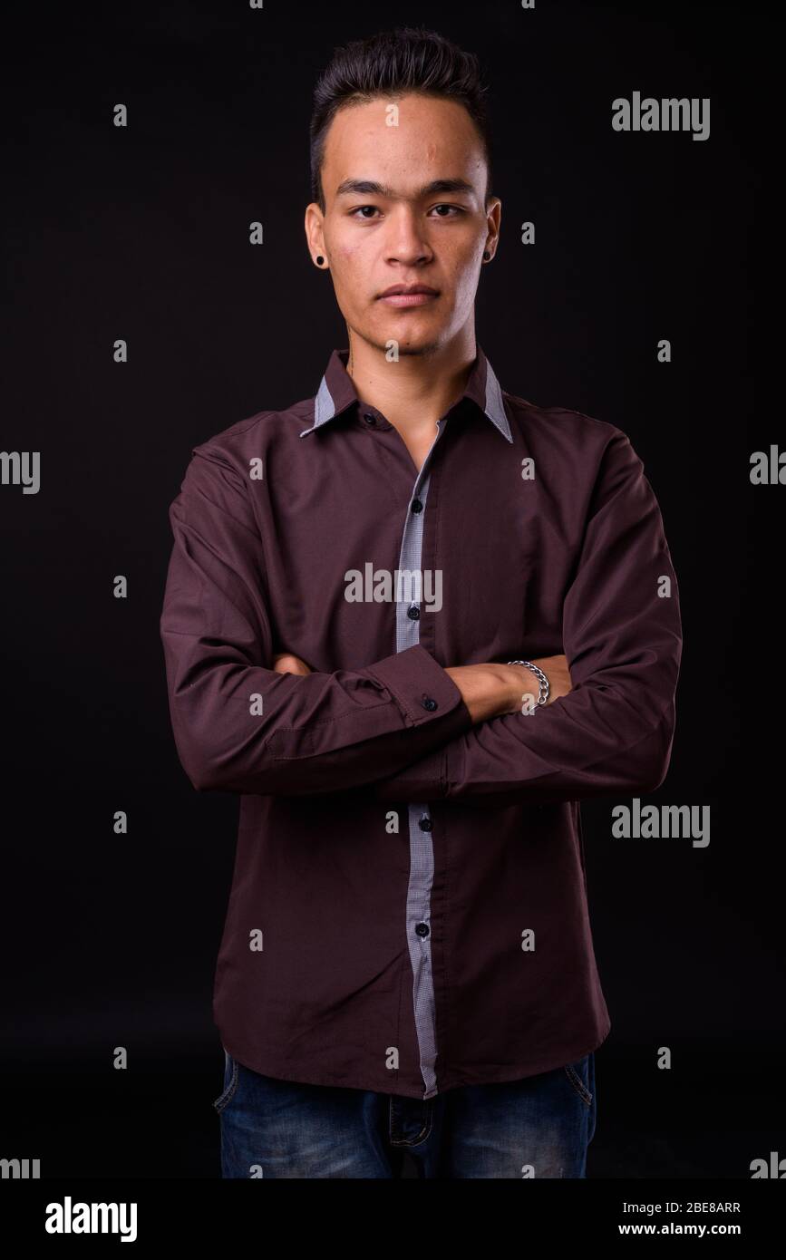 Portrait of young handsome Indian businessman with arms crossed Stock ...