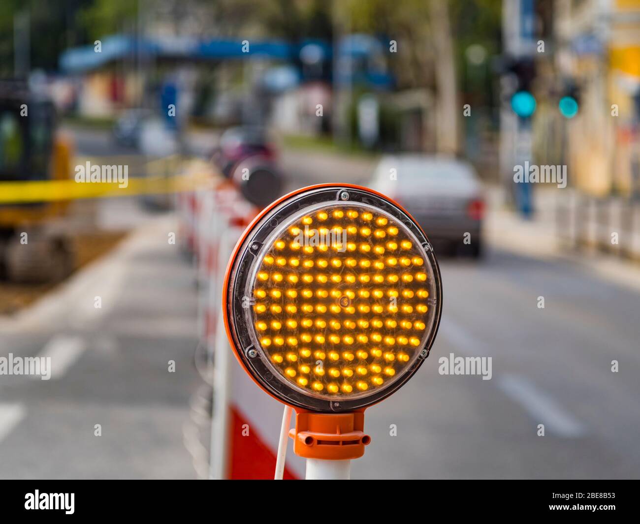 Road multiple Yellow LED lamps circular signal slow traffic warning sign work in progrss passing by car vehicle Stock Photo
