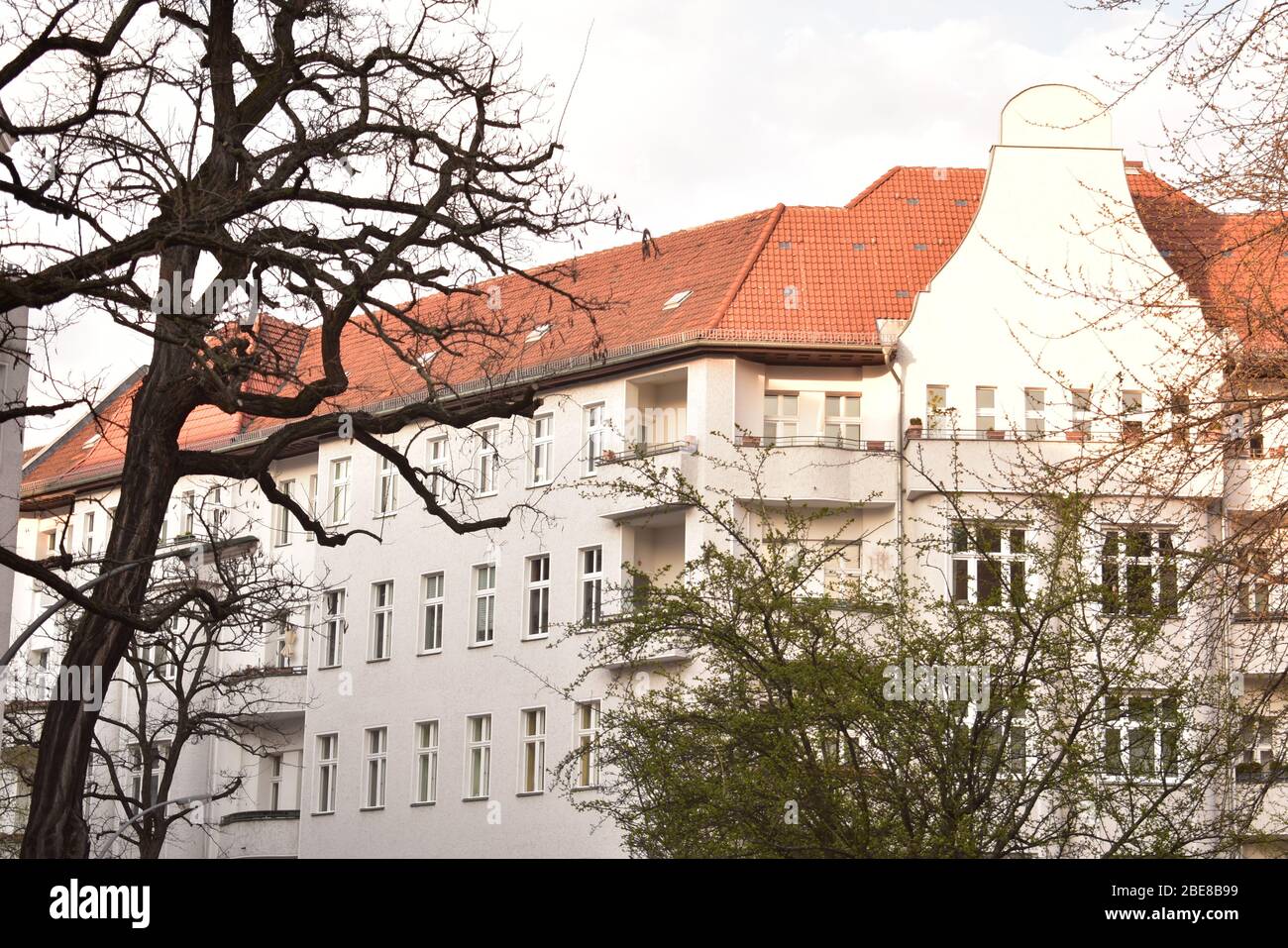 Trees in front of green apartment facade in Schoneberg Berlin Stock Photo Alamy