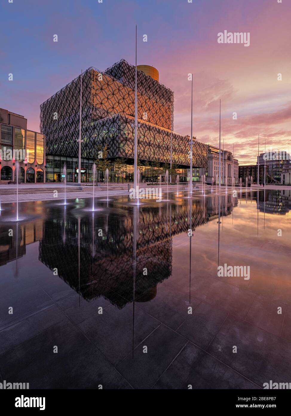 Library of Birmingham and water feature photographed at dawn from Centenery Square, Broad Street, Birmingham, United Kingdom. Stock Photo