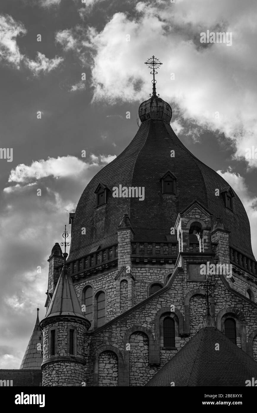 black and white image of the backside of the 19th century St Lambertus church with a spectacular view on the dome with dramatic sky Stock Photo