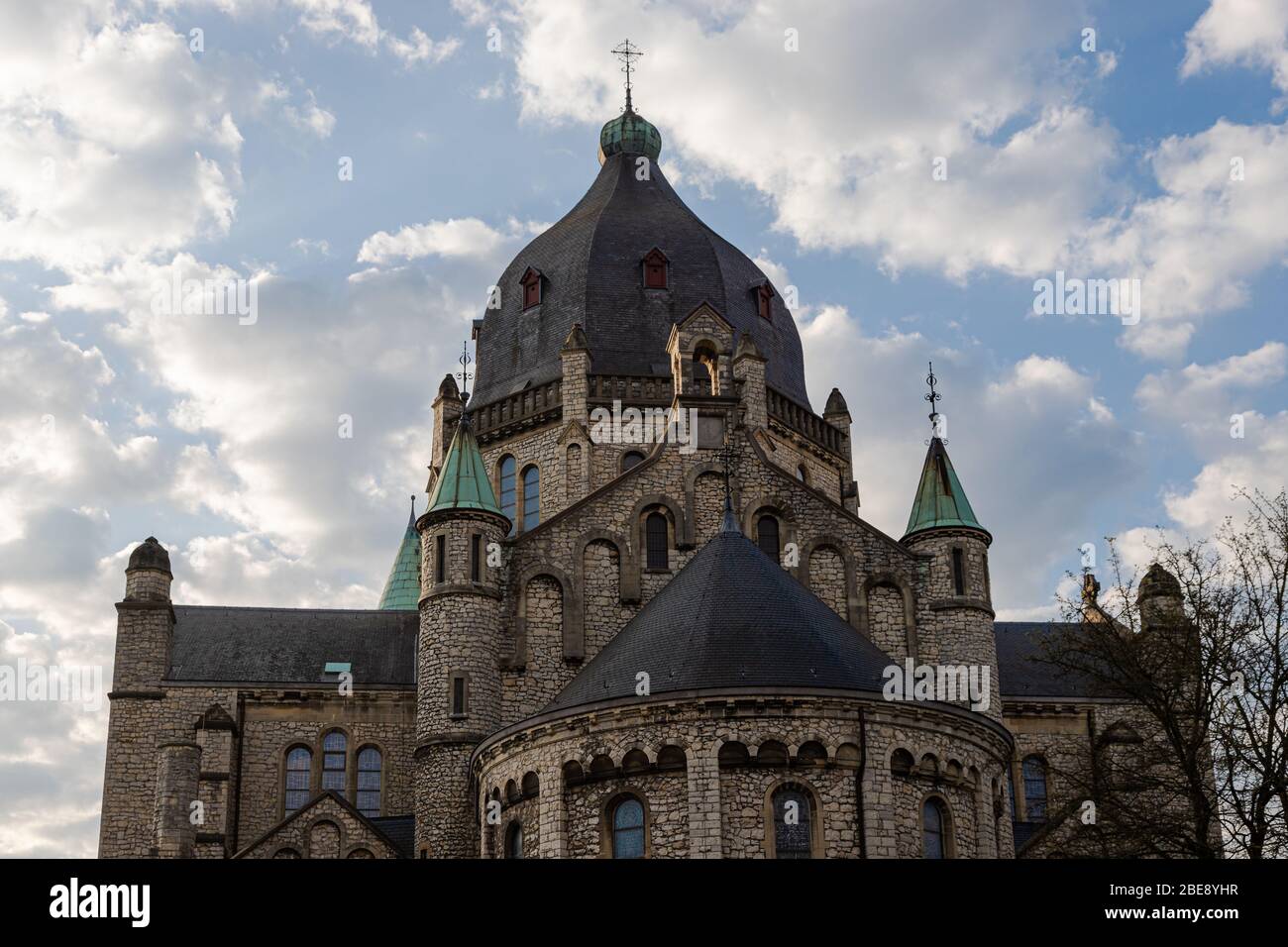 Partial view of the frontside of the 19th century St Lambertus church (english St Lambertus) with a spectacular view on the dome with dramatic clouds Stock Photo