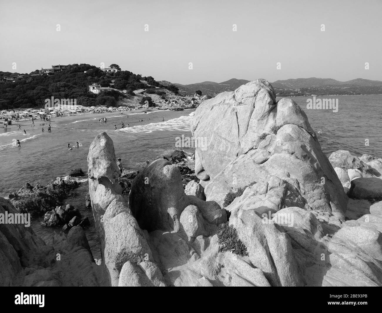 Tourists and bathers on the sand and rock beaches typical of Sardinia. Stock Photo