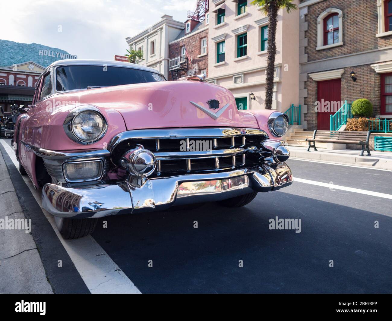 Verona, Italy - September 7, 2019: Vintage pink car parked along a street and in the background the word Hollywood. Stock Photo
