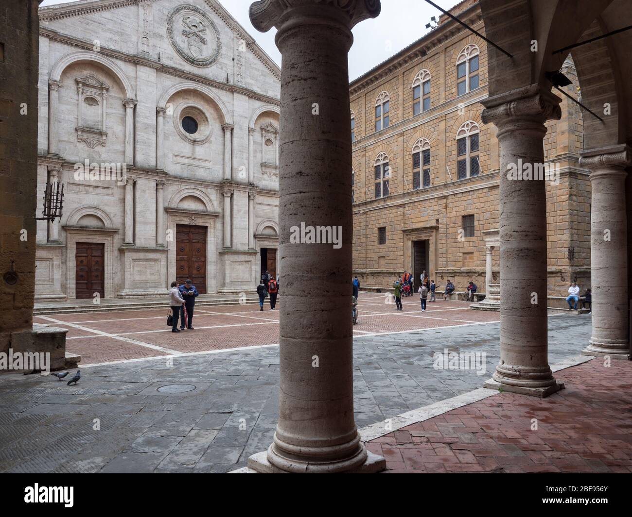 Pienza, Italy - April 23, 2019: The cathedral of Santa Maria Assunta is the main place of worship in Pienza. View from the opposite colonnade. Stock Photo