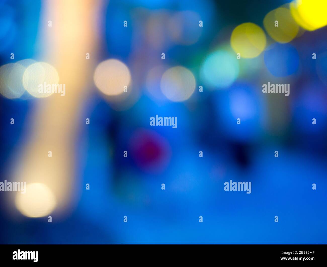 Background formed by blurred reflections of colored lights. Stock Photo