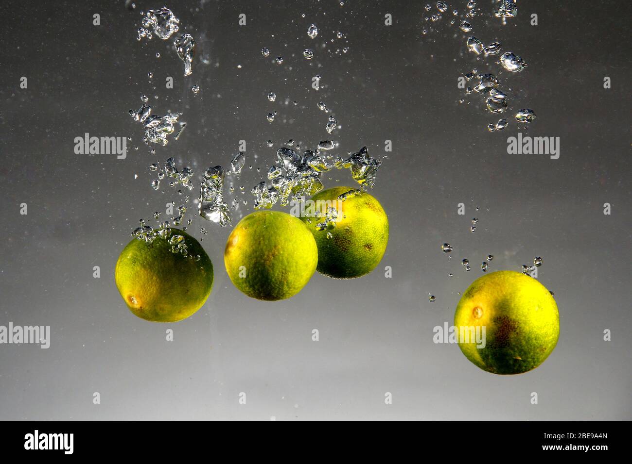 Photo of Calamondin or Philippine lime or calamansi dropped in water Stock Photo