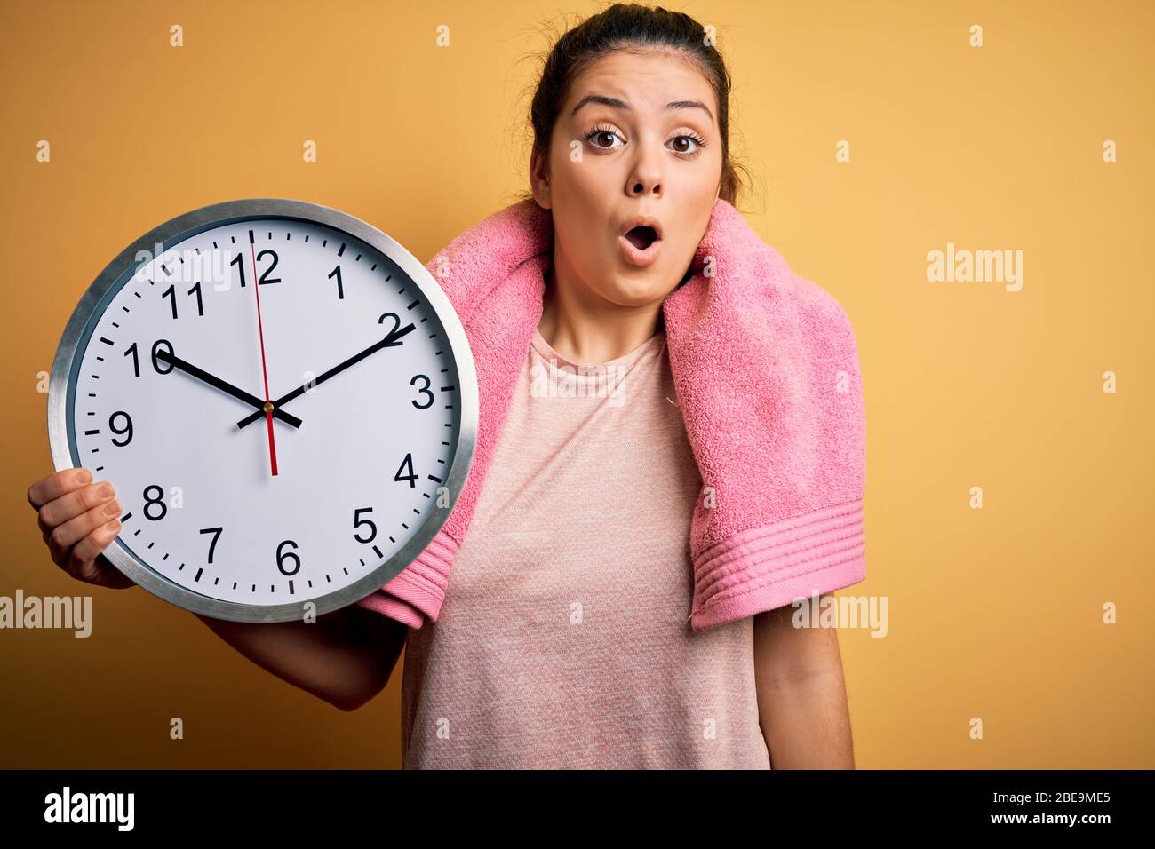 Young beautiful brunette sportswoman wearing towel doing countdown ...
