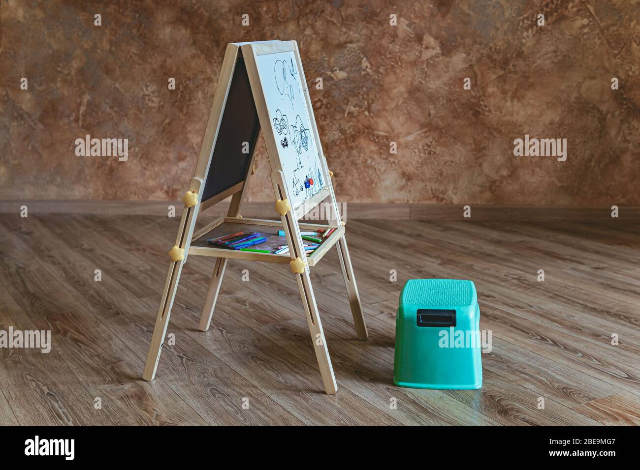 Drawing board with little empty chair, no people Stock Photo