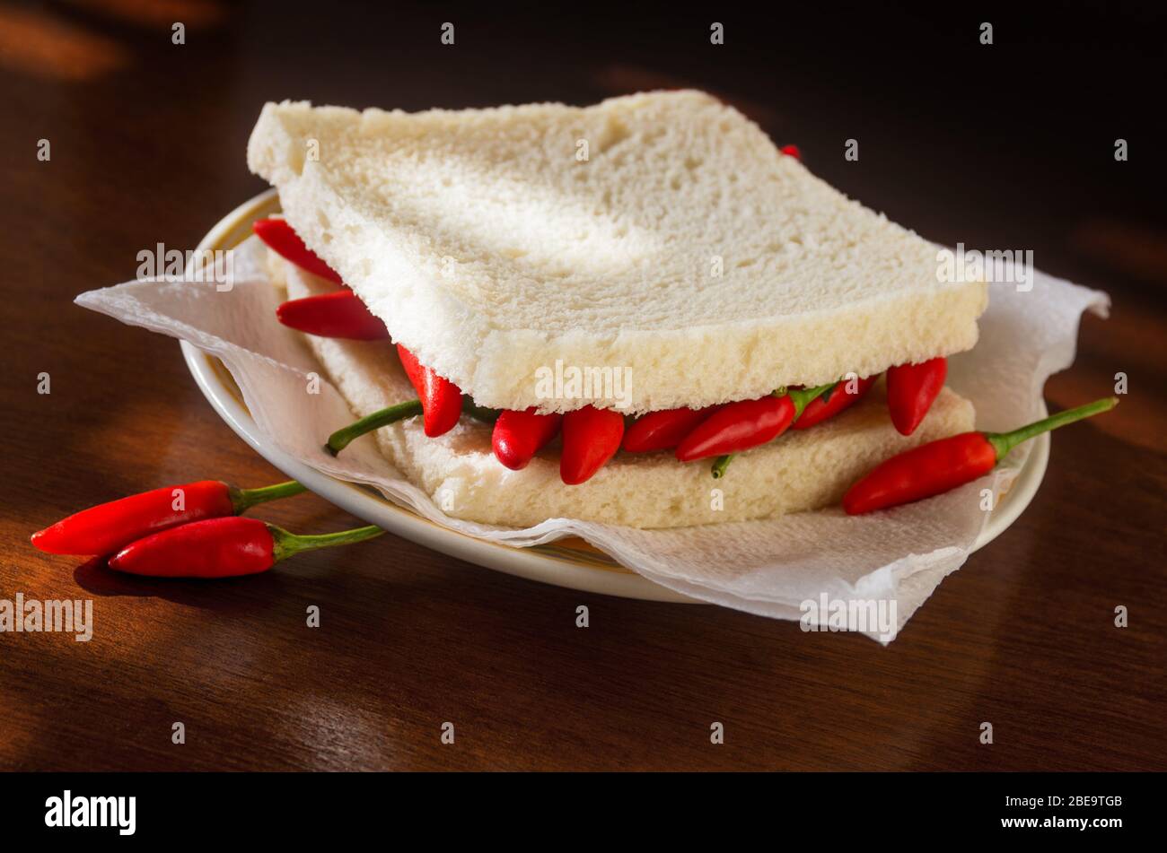 Closeup on a spicy hot chili pepper sandwich in a plate Stock Photo