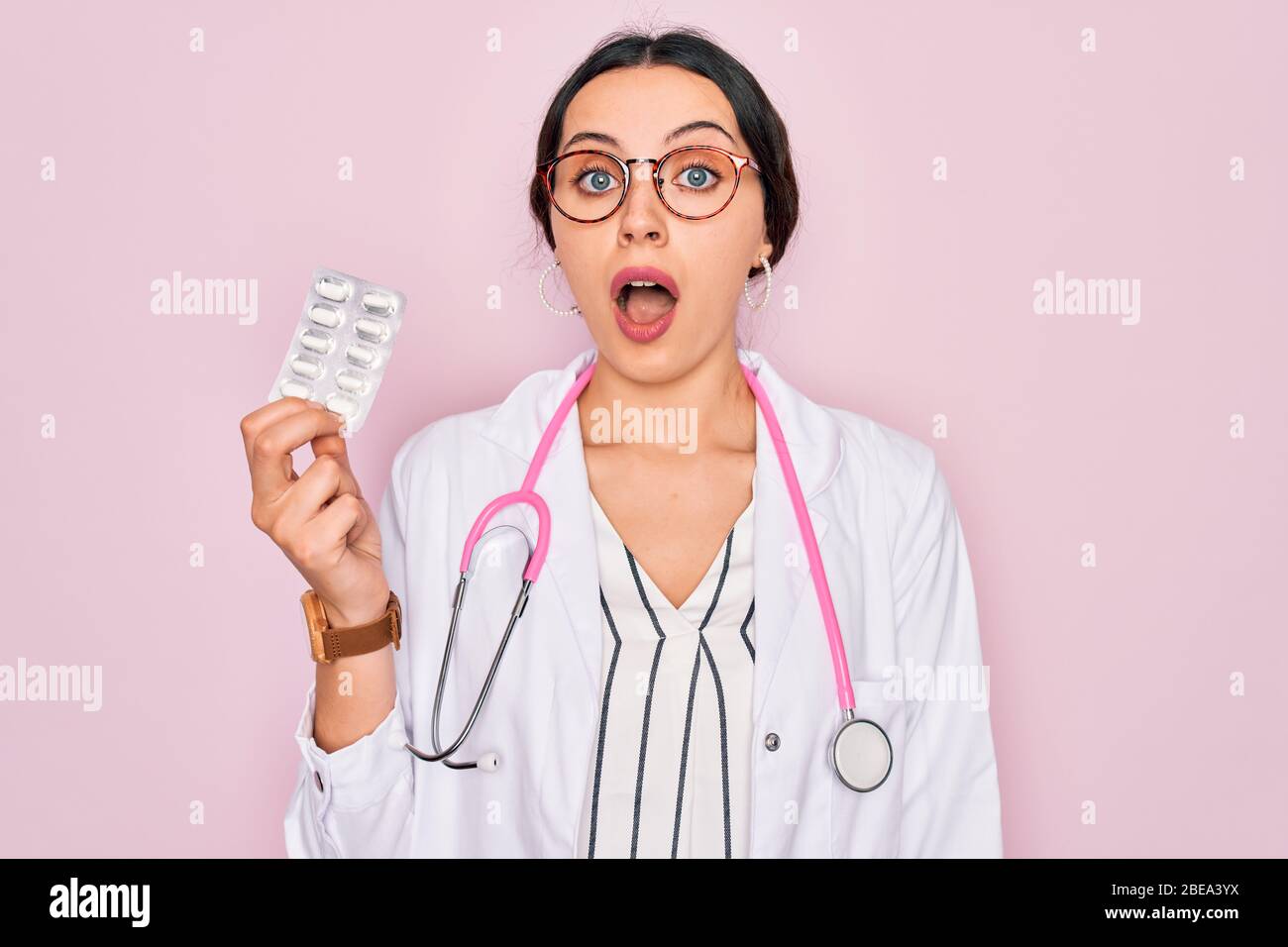 Young beautiful doctor woman with blue eyes wearing stethoscope holding