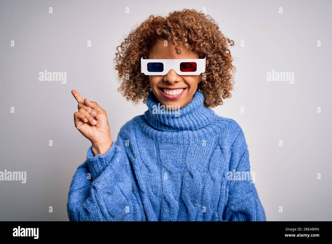 Young african american curly woman wearing 3d glasses over isolated ...