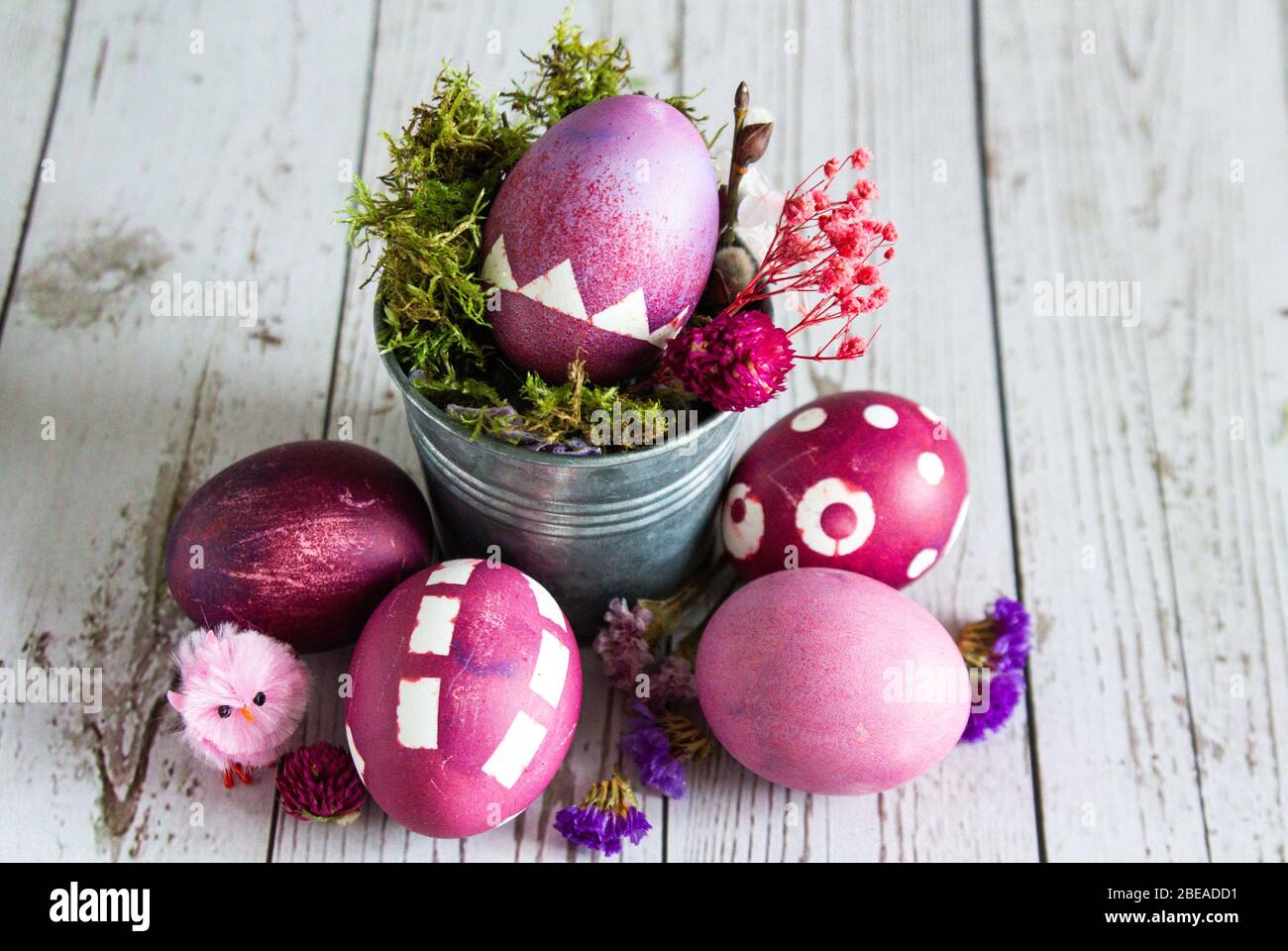 Rose colored Easter egg composition. Rustic background. Stock Photo