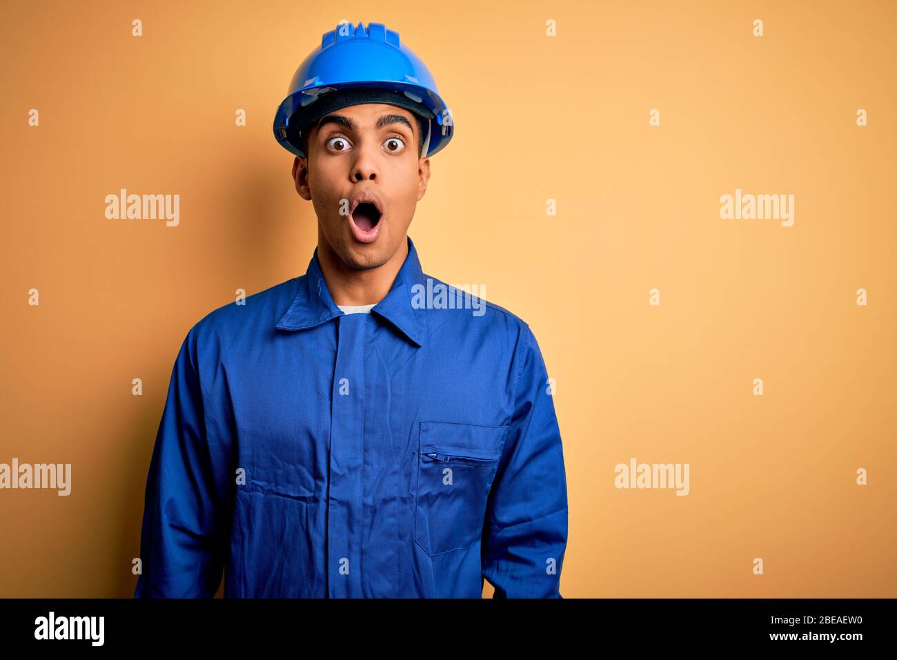 Young handsome african american worker man wearing blue uniform and ...