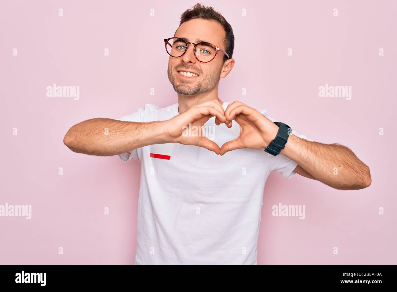 Handsome man with blue eyes wearing sticker with hello my name is ...