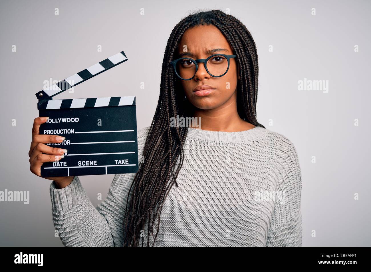 Young african american director girl filming a movie using clapboard ...