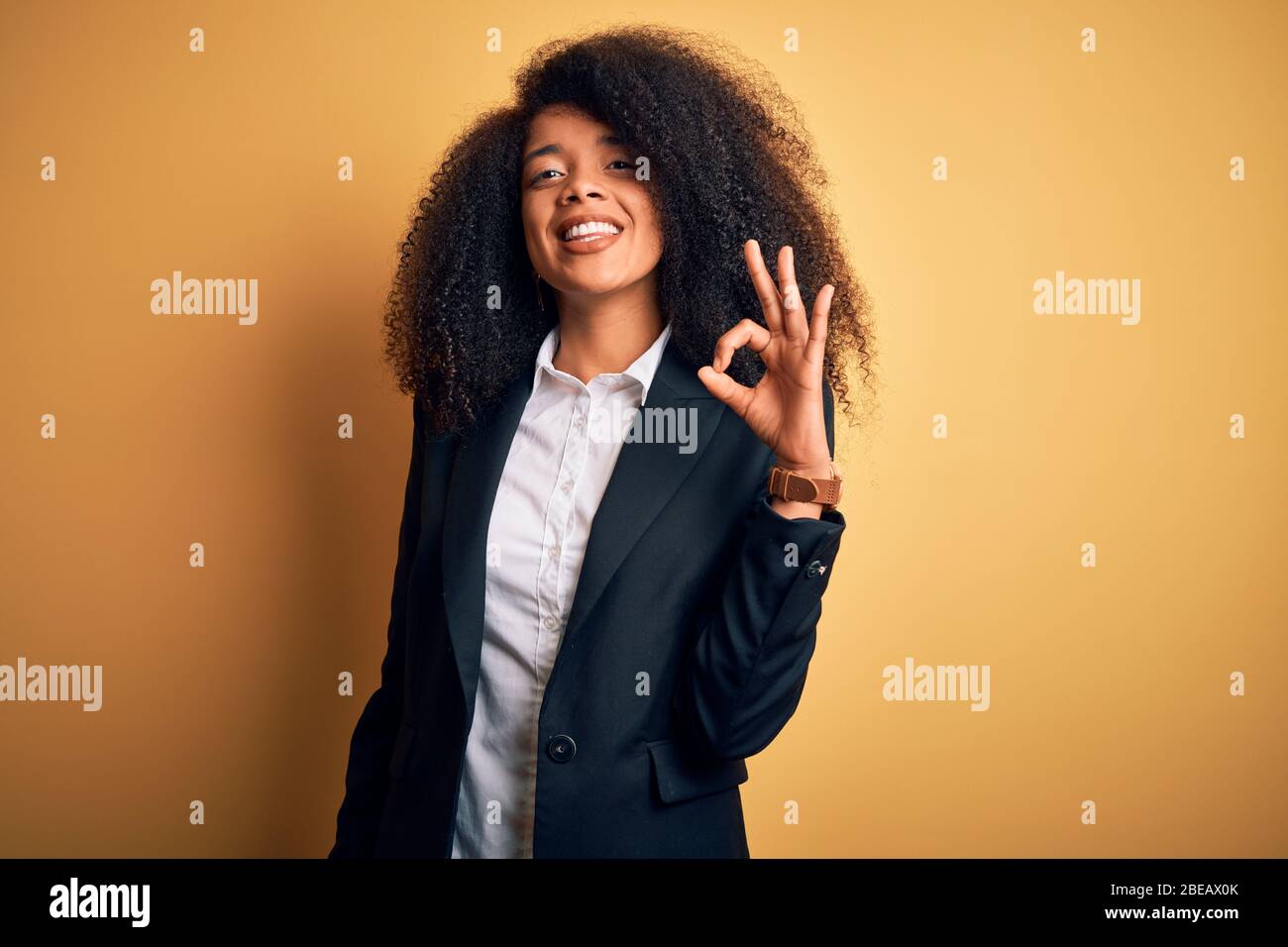 Young beautiful african american business woman with afro hair wearing ...