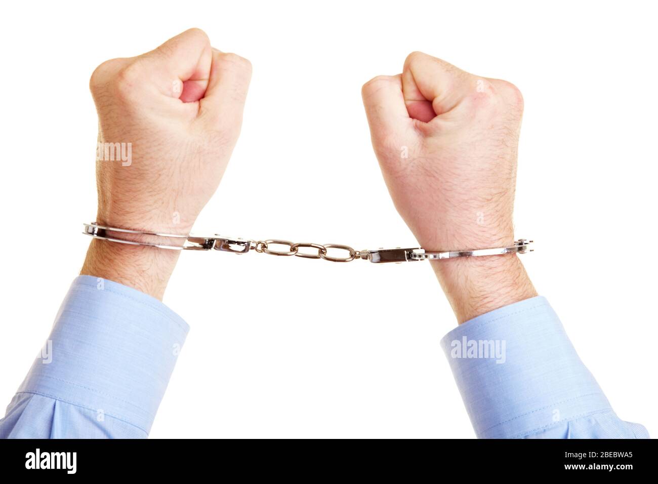 Two hands in handcuffs are clenched into fists Stock Photo Alamy