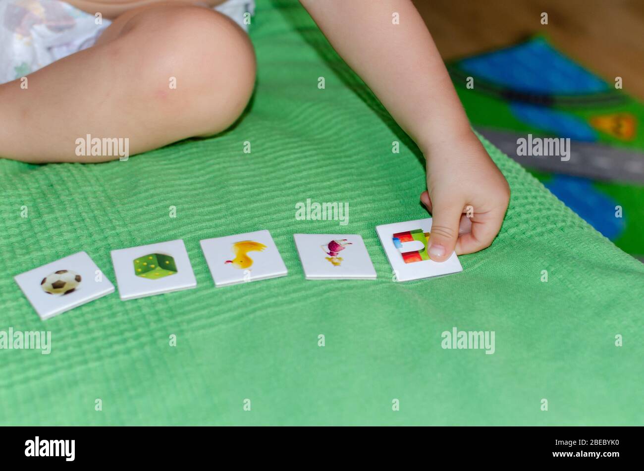 child lining up toys
