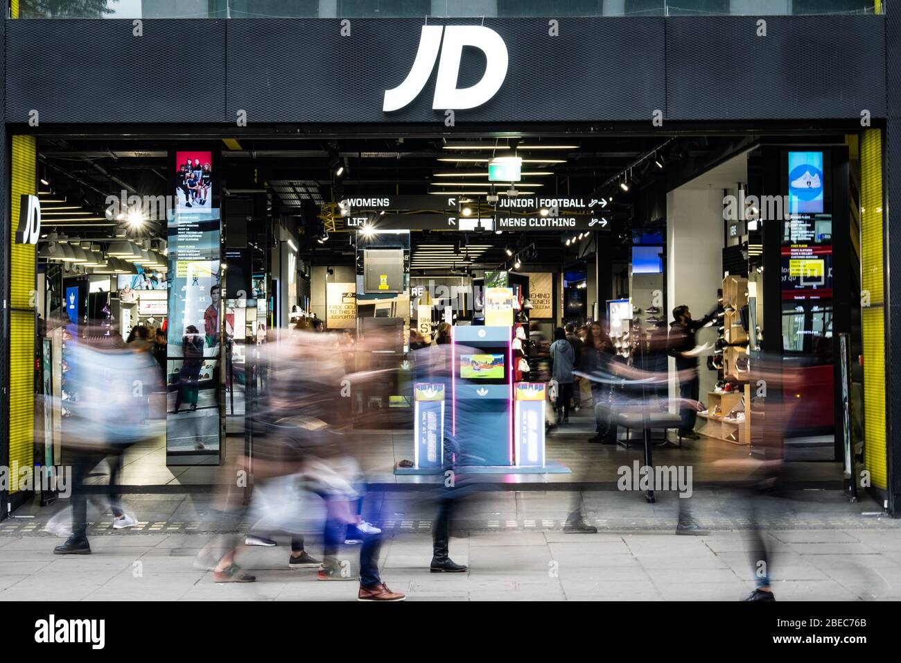 LONDON- JD Sports store with motion blurred shoppers- a casual British fashion and sports goods brand. Stock Photo