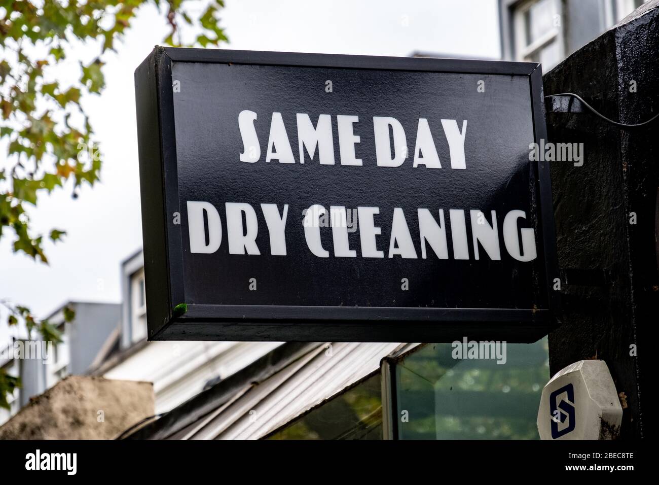 'Same Day Dry Cleaning' sign on west London high street Stock Photo Alamy