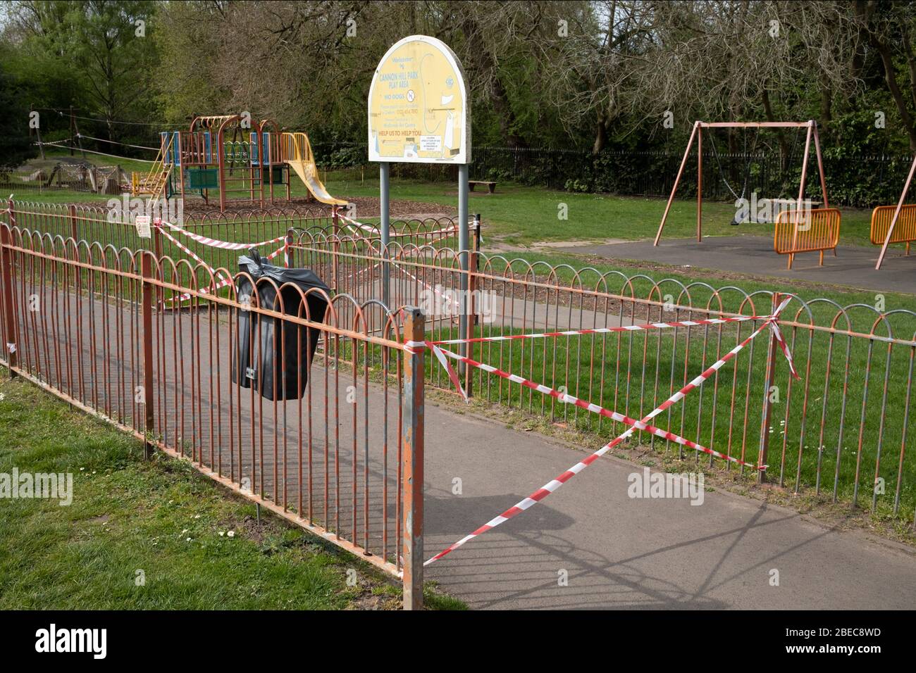 Childrens playground is cordoned off to prevent children getting too close while playing in Canon Hill Park as Coronavirus is felt on a local level on 12th April 2020 in Birmingham, England, United Kingdom. People here, in what is normally an incredibly busy urban park are mainly abiding the stay at home message, and those out exercising are doing so with care. Coronavirus or Covid-19 is a new respiratory illness that has not previously been seen in humans. While much or Europe has been placed into lockdown, the UK government has announced more stringent rules as part of their long term strate Stock Photo