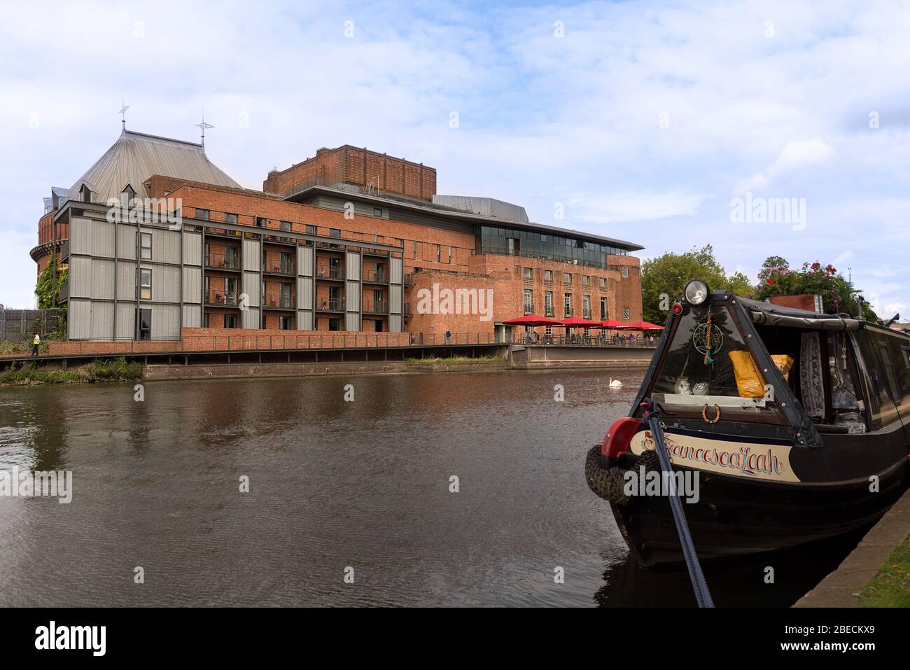 The landmark Royal Shakespeare theatre of Stratford on Avon viewed across the river Avon with canal boat. Stock Photo