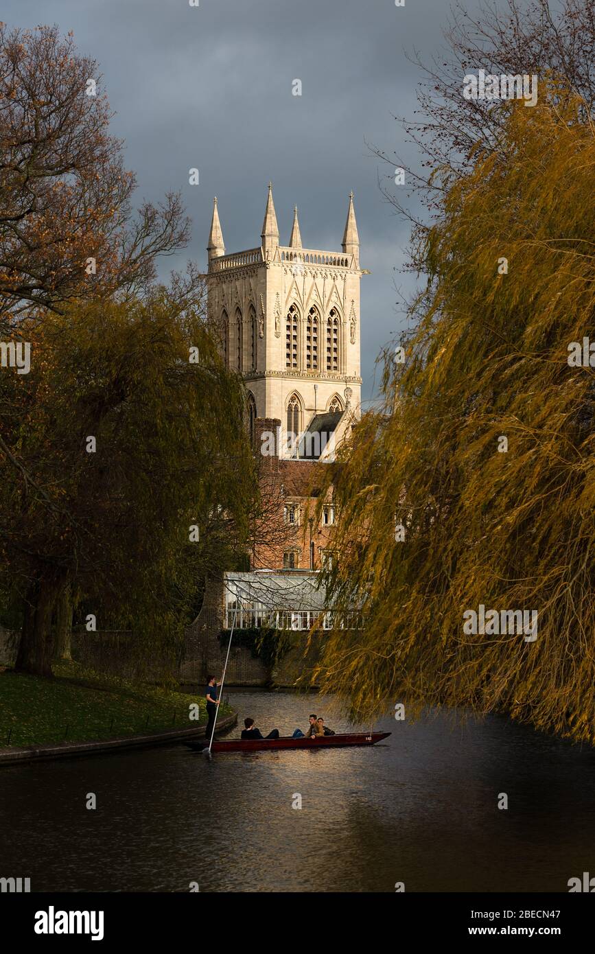 Students punt along the river Cam with a back drop of an illuminated St John's College chapel. Stock Photo