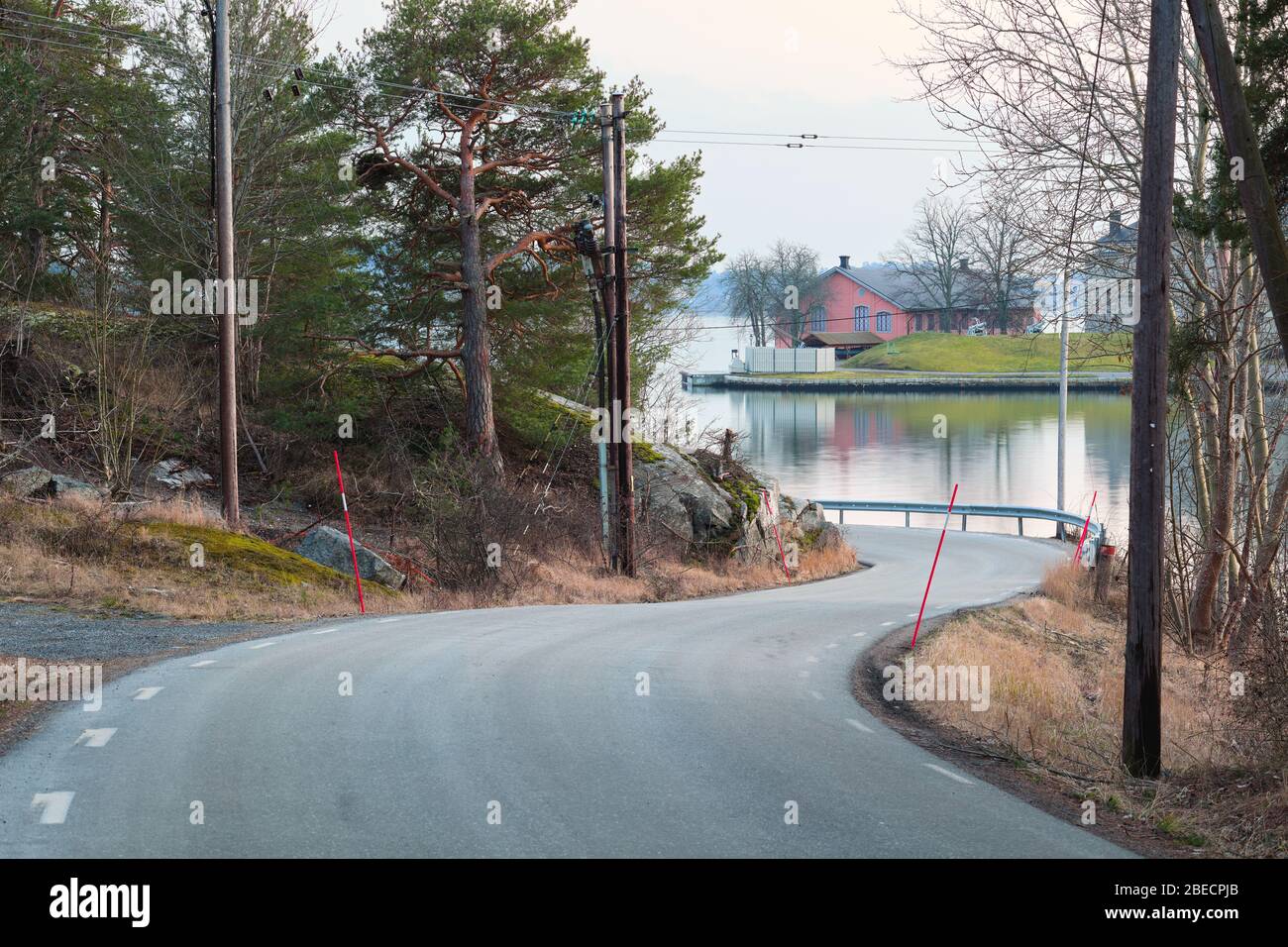 Curvy road in Rindö with outlook toward Vaxholm Fortress outside Vaxholm, Sweden Stock Photo