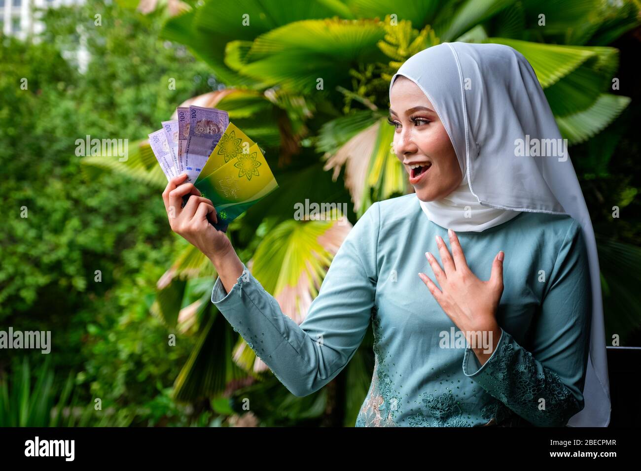 A portrait of young malay woman with surprise happy expression 