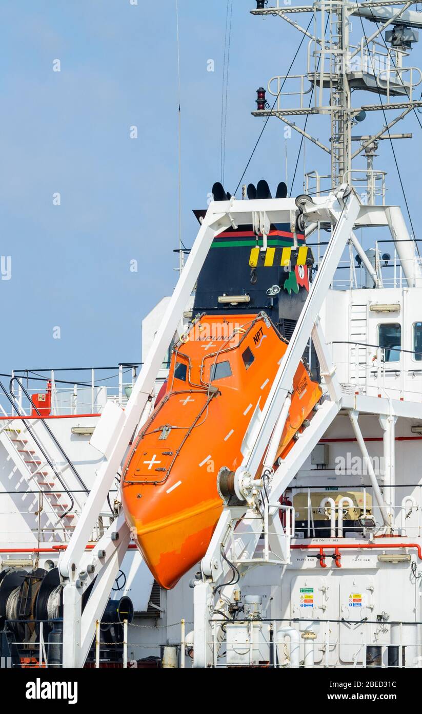 NPT fully enclosed freefall lifeboat at the rear of an oil tanker. Free fall lifeboat at the back on a large ship. Stock Photo