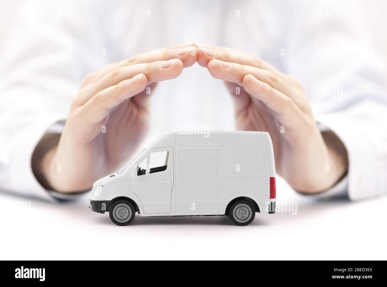 Transport white van car protected by hands Stock Photo