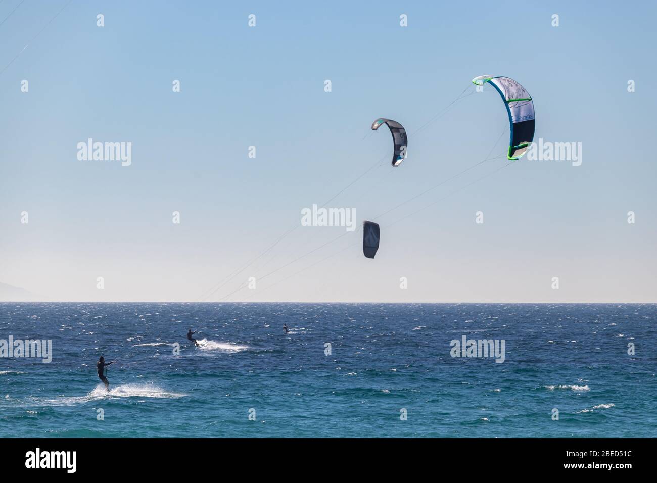 Tarifa, Spain. 3rd February, 2020. Many kitesurfers doing sports in the Atlantic ocean near the windy Bolonia beach Stock Photo